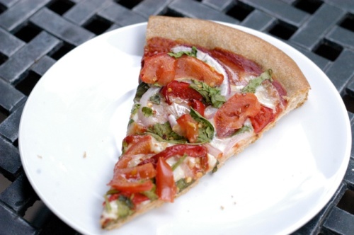 Everyone needs a staple pizza crust recipe! Our stand-by ingredients usually consist of the sauce, fresh mozzarella, tomatoes, spinach and onion. This slice also has roasted red pepper and fresh basil.